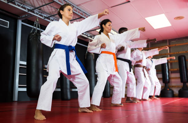 istock Polyethnic men and women in kimono exercising kata 1414914442