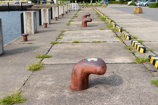 Bollard for mooring. Place for fixing the ship. Mooring. Iron posts. At the seaport. The concept of navigation.