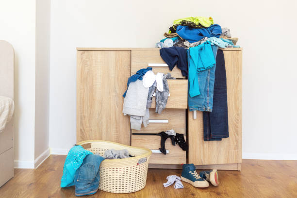 chest of drawers, with clothes in mess, a basin for collecting linen for washing - domestic car color image horizontal car imagens e fotografias de stock