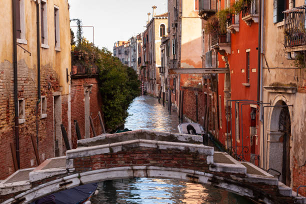 istock The old bridge made with red bricks on the typical canal in Venice 1414917243