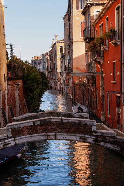 istock The old bridge made with red bricks on the typical canal in Venice 1414917250