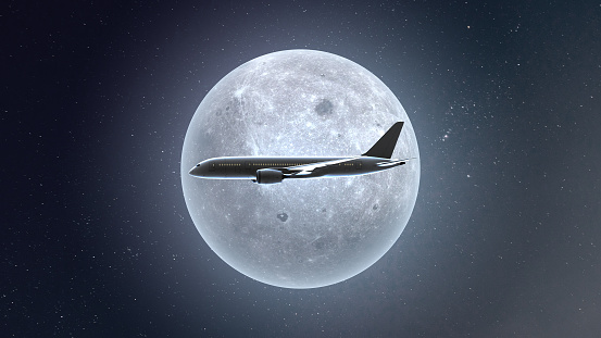 Airplane flying in the full moon