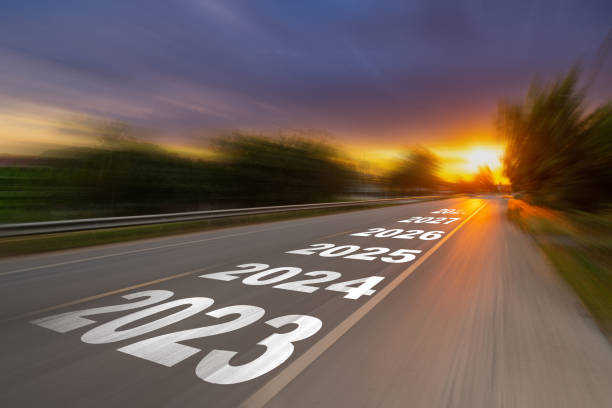 istock Motion blur empty asphalt road and New year 2023 concept. Driving on an empty road to Goals 2023 with sunset. 1414919042