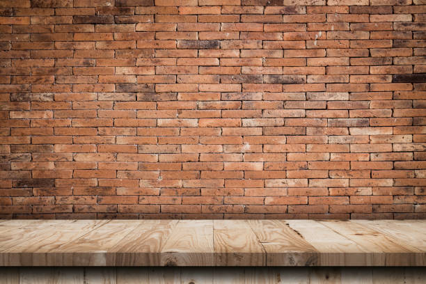 istock Empty wooden table top and red brick wall and rough crack background texture 1414919146