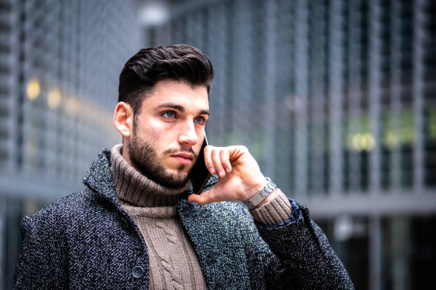 istock portrait of a young man with intense looking, modern businessman using smartphone for working, male model with blu eyes, dark hair and short beard, confident and serious expression 1414920264