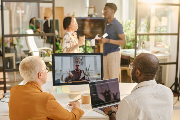 istock Programmers talking online with colleague during online meeting 1414921999