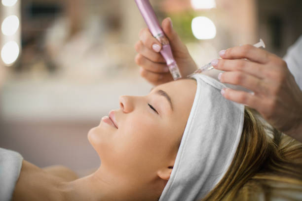 Enjoying facial treatment  in a beauty salon. stock photo