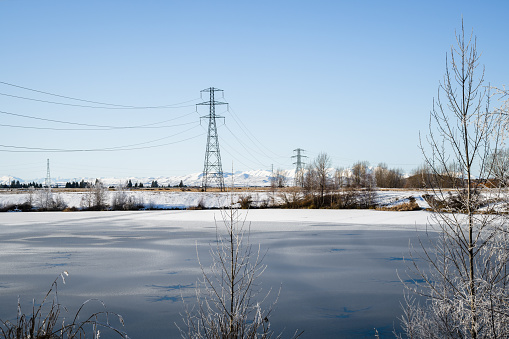 High voltage transmission towers and powerlines among hoar frost,  Twizel, South Island