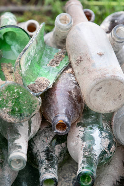 istock Empty glass bottles in a pile. Waste collection and sorting 1414925409