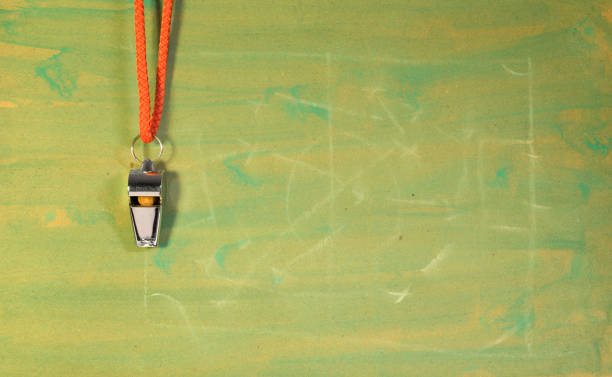 istock Whistle of soccer referee or trainer and soccer tactics scribble on green background. Great soccer event this year, large free copy space 1414925616