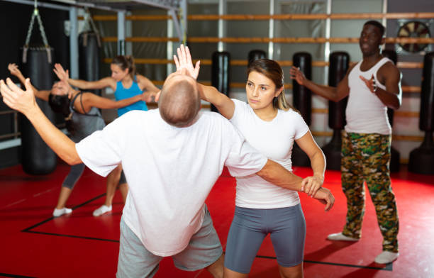 istock Girl self defense training gym learning to do painful grip 1414925967