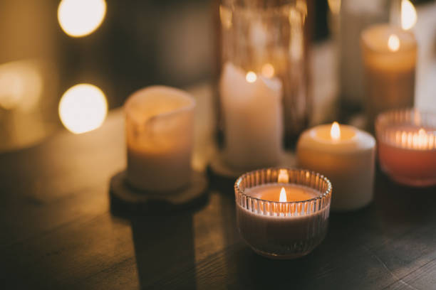 istock Candles in glasses on wooden table. 1414927260