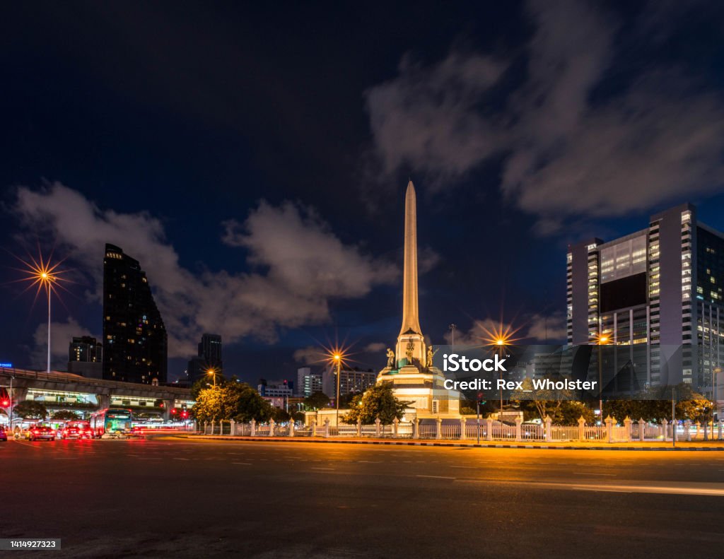 Victory Monument in Bangkok at night Light trails from vehicles and the Victory Monument in downtown Bangkok Asia Stock Photo