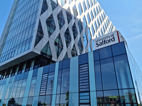 A Salford University building on Salford Quays Manchester showing there logo.
