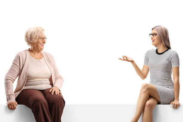 istock Pensioner and a young woman sitting on a panel and having a conversation 1414932906