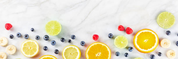 istock Fresh summer food menu banner. Fruit slices, shot from above 1414934032