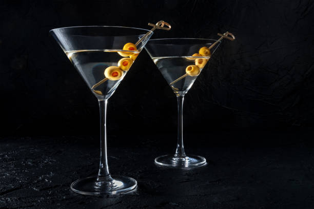 istock Martini, two glasses with spicy olives, on a black background 1414934180