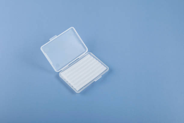 Ortho wax in plastic box. Useful thing to help well with braces. Orthodontic wax relieves irritation from braces. Blue background, copy space Ortho wax in plastic box. Useful thing to help well with braces. Orthodontic wax relieves irritation from braces. Blue background, copy space. relieves stock pictures, royalty-free photos & images