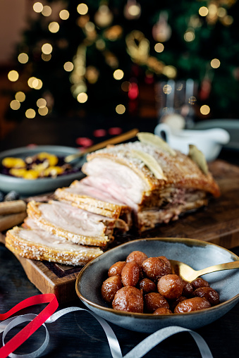 Flaeskesteg or Roast Pork is a traditional Christmas dish. The skin of the pork is cut then salt is rubbed into it, then dried bay leaves and cloves are inserted into the cuts to give the cooked meat a distinctive taste and smell. Colour, vertical format with some copy space.
