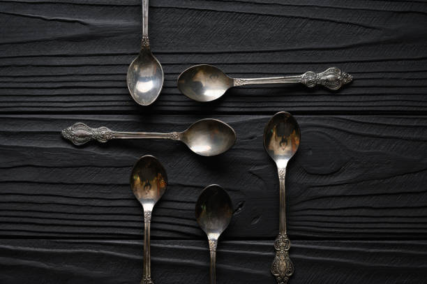 istock Directly above a shot of old spoons on a black table 1414941544