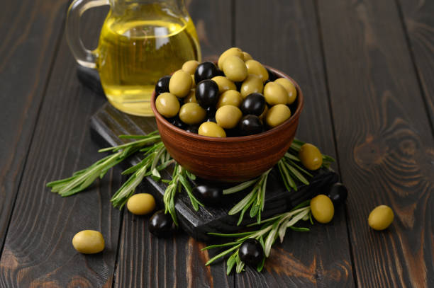 istock Black and green olives on a dark wooden rustic background. 1414943289