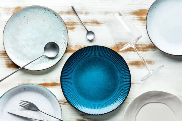 istock Modern tableware set with cutlery and a vibrant blue plate, with a glass 1414943335