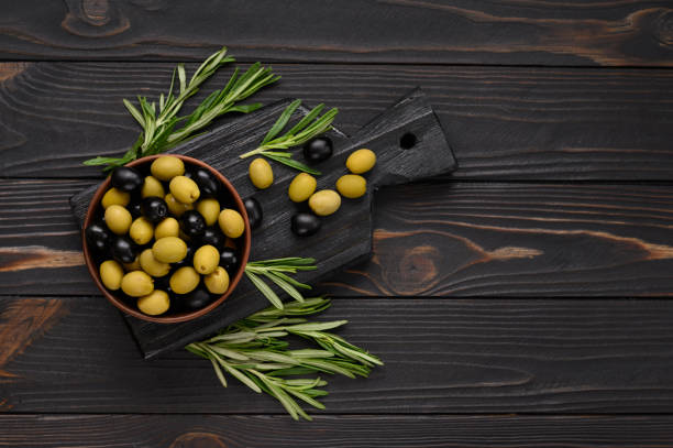 istock Black and green olives on a dark wooden rustic background. 1414943573