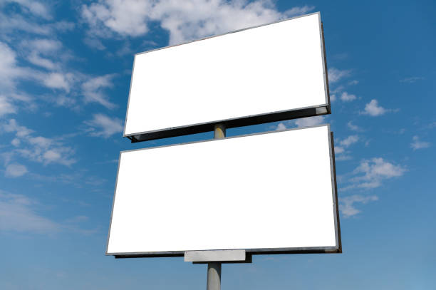 Billboard white blank with room to add your own text. Background with white cloud and blue sky for outdoor advertising, banners with clipping path stock photo