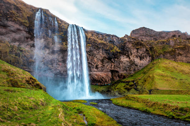 istock Seljalandfoss waterfall and green lawn in Iceland 1414944042
