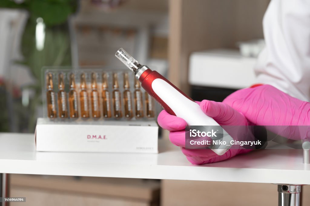 The beautician holds in his hands a dermapen, a tool for mesotherapy and cell regeneration. The cosmetologist holds in his hands a dermapen, a tool for mesotherapy and cell regeneration, a cosmetologist's office. Dermatologist Stock Photo