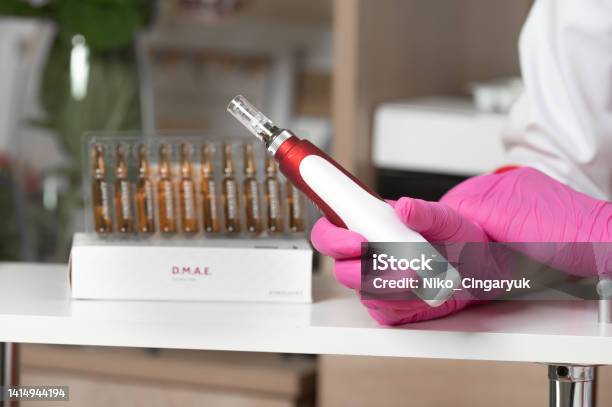 The Beautician Holds In His Hands A Dermapen A Tool For Mesotherapy And Cell Regeneration Stock Photo - Download Image Now