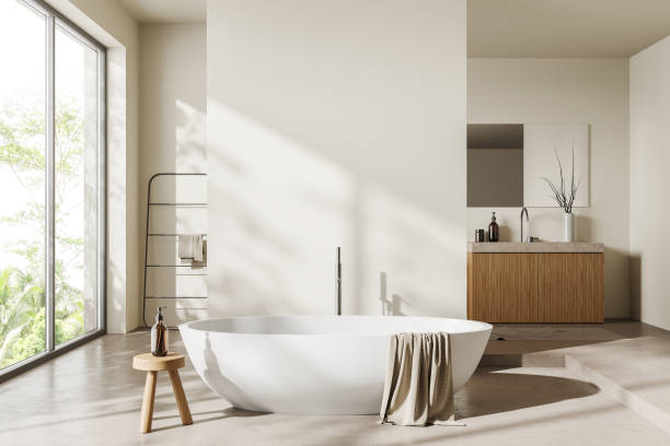 istock Light bathroom interior with bathtub and washbasin, panoramic window. Mockup 1414944392