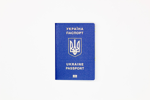 Passport of Ukraine. The cover of the State document of the foreign Ukrainian Passport with the coat of arms of Ukraine in blue on a white background with an electronic chip. Isolated. Top view