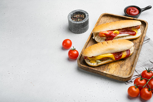 Barbecue Grilled Hot Dog with ketchup, on white stone table background, with copy space for text.