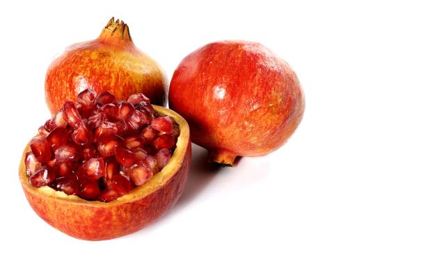 Pomegranate fruit on white background with its seeds Pomegranate fruit on white background with its seeds pomegranate in spanish stock pictures, royalty-free photos & images