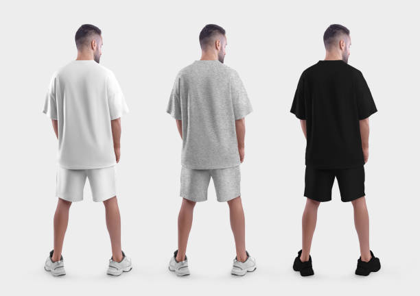 istock Oversized suit mockup, white, black, heather t-shirt, shorts on a guy in sneakers, back view, isolated on background. 1414945646