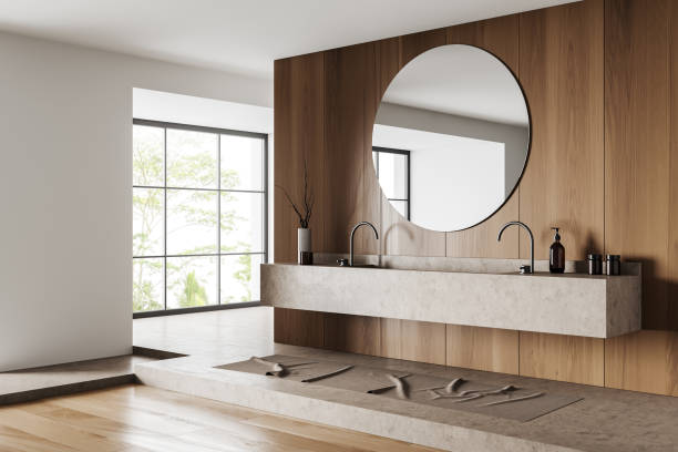 istock Light bathroom interior with washbasin and mirror, accessories and window 1414947097