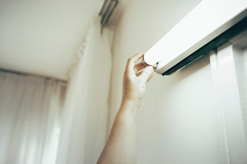 Woman replacing light bulb at home. Power save LED lamp changing