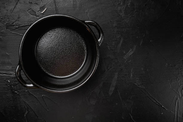 istock Empty cooking pot with copy space for text or food with copy space for text or food, top view flat lay , on black dark stone table background 1414948952