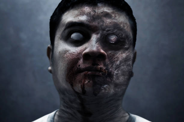 istock Scary zombie man on dark background 1414949687