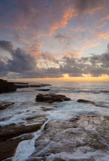 istock Sunrise over rocky ocean seascape 1414952296