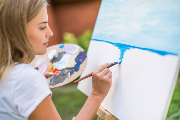 istock Woman  painting 1414952412
