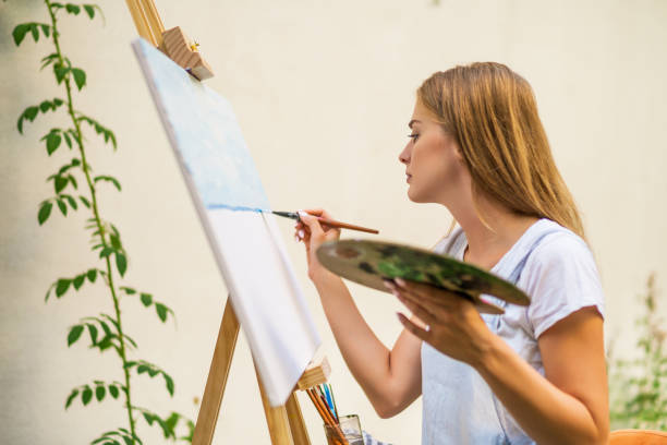 istock Woman  painting 1414952413
