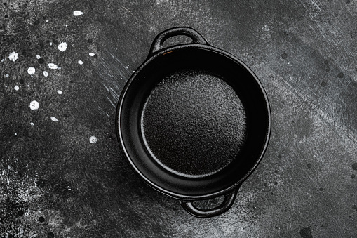 Black Empty clay pot set with copy space for text or food with copy space for text or food, top view flat lay, on black dark stone table background