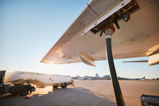 Refueling of airplane at airport stock photo