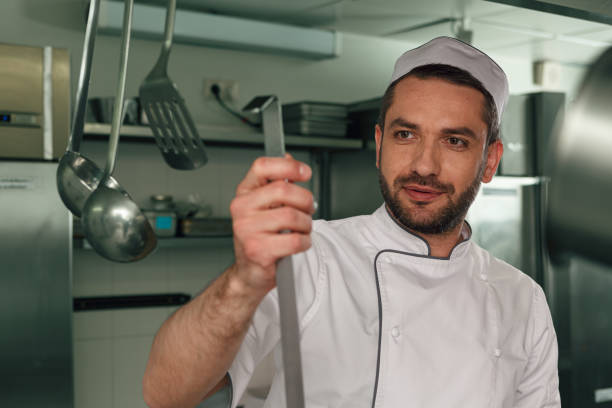 istock Chef cooking tasty dish in kitchen of restaurant using modern equipment 1414954643