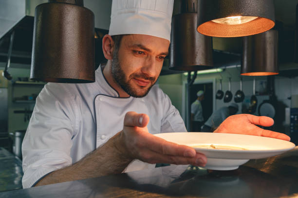 istock Professional chef checks dish just before serving it to customer in restaurant 1414955485