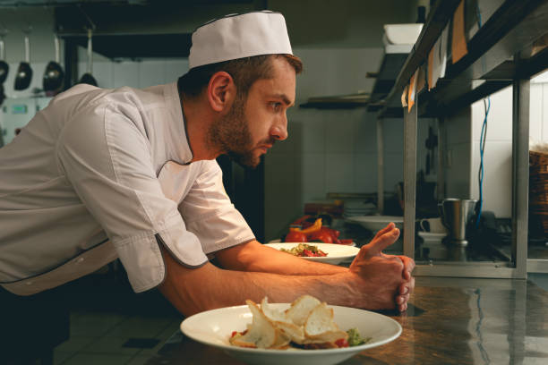 istock Tired chef on kitchen restaurant waiting for a new order 1414955532