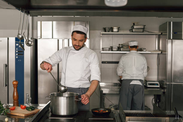 istock Chef cooking tasty dish in kitchen of restaurant using modern equipment 1414955567