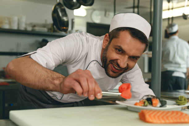 istock Sushi master prepares sushi for serving in modern commercial kitchen 1414956074